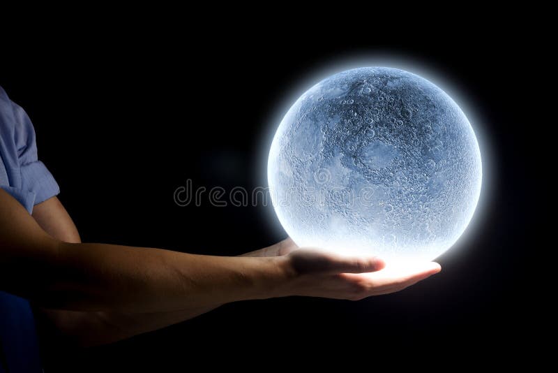 Close up of human hand holding blue glowing moon. Close up of human hand holding blue glowing moon