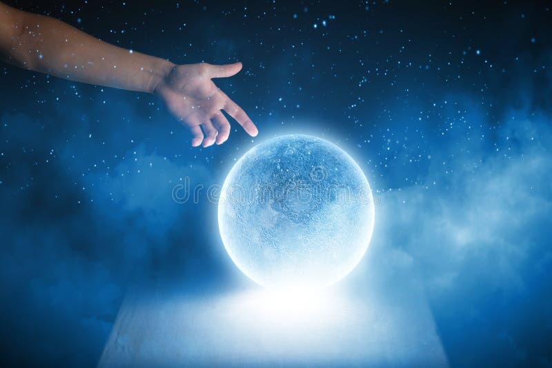 Close up of human hand touching blue glowing moon. Close up of human hand touching blue glowing moon