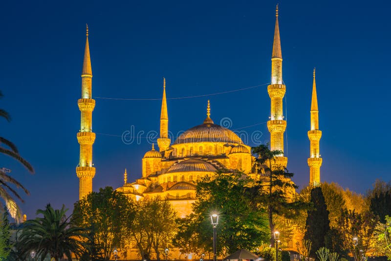 Blue Mosque at night with golden illumination, wide view of Istanbul in dusk. Sultanahmet Camii mosque with six minarets stock images Blue Mosque at night with golden illumination, wide view of Istanbul in dusk. Sultanahmet Camii mosque with six minarets stock images