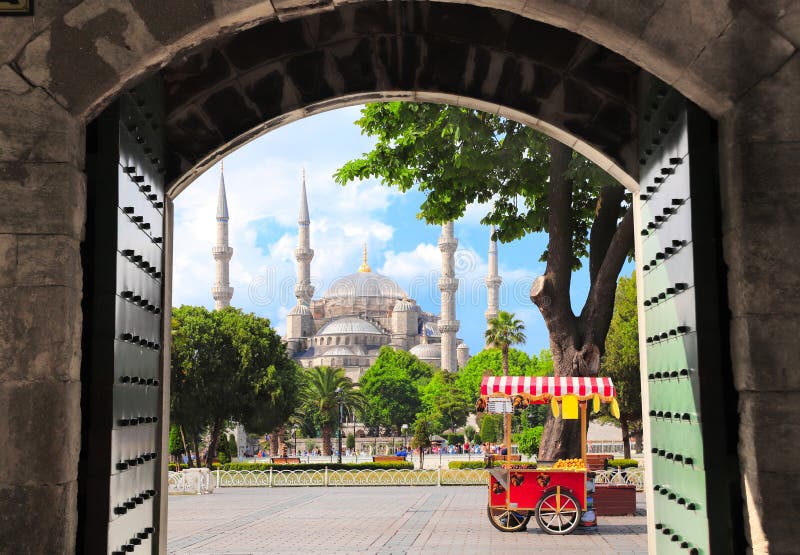 View through the old gate on Blue mosque Sultan Ahmet mosque and traditional turkish chestnut and corn cart, Sultanahmet Square, Istanbul, Turkey. View through the old gate on Blue mosque Sultan Ahmet mosque and traditional turkish chestnut and corn cart, Sultanahmet Square, Istanbul, Turkey