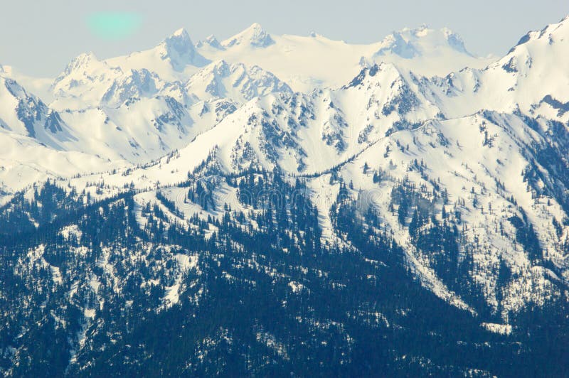 Blue mountains and snow capped peaks stock photo