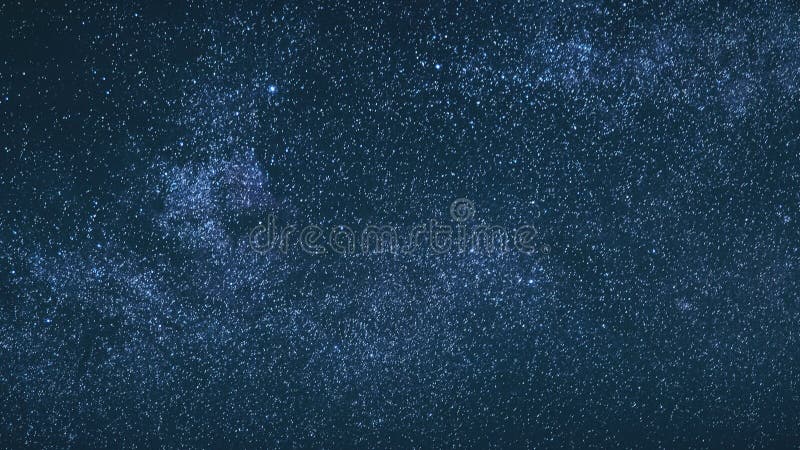 Blue Night Starry Sky With Glowing Stars. Bright Glow Of Sky Stars And Milky Way Galaxy. 4K. Natural Background Backdrop