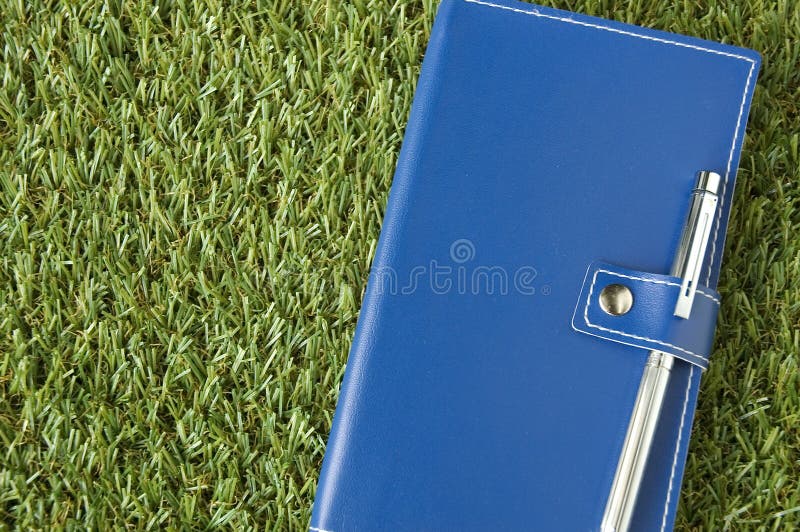 Blue notebook put on grass