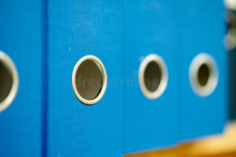 Blue office folders with round metal rings at the end of the folder