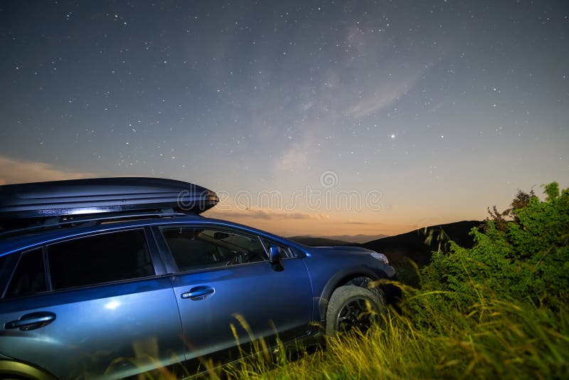 Blue Offroad SUV Car with Roof Trunk on Background of Very Beautiful Night  Starry Sky after Sunset. Freedom and Travel Stock Photo - Image of  constellation, galaxy: 266614156