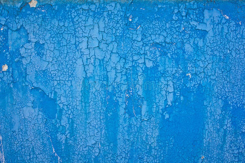 Blue old peeling paint pattern of obsolete wall.