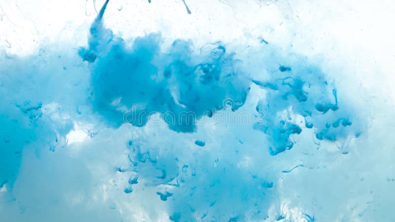 Blue paint dripping and dissolving in water