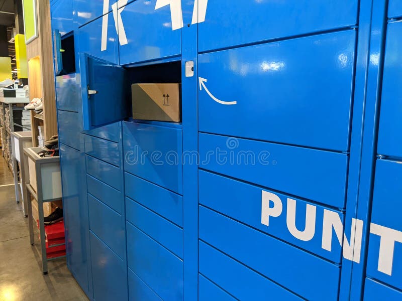 Blue parcel collection lockers in a store stock image