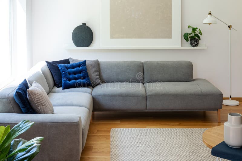 Blue Pillows on Grey Corner Sofa in Apartment Interior with Lamp and Plant Next To Poster. Real Photo Stock Image - Image of cushions, living: 127288045 Blue Pillows on Grey Corner Sofa in Apartment Interior with Lamp and Plant Next To Poster. Real Photo Stock Image - Image of cushions, living: 127288045