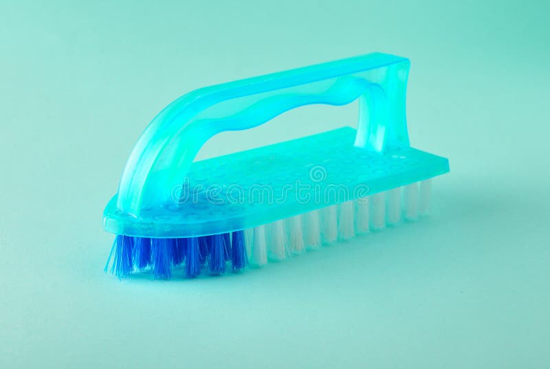 Blue Plastic Brush for House Cleaning on a Blue Background Stock Photo