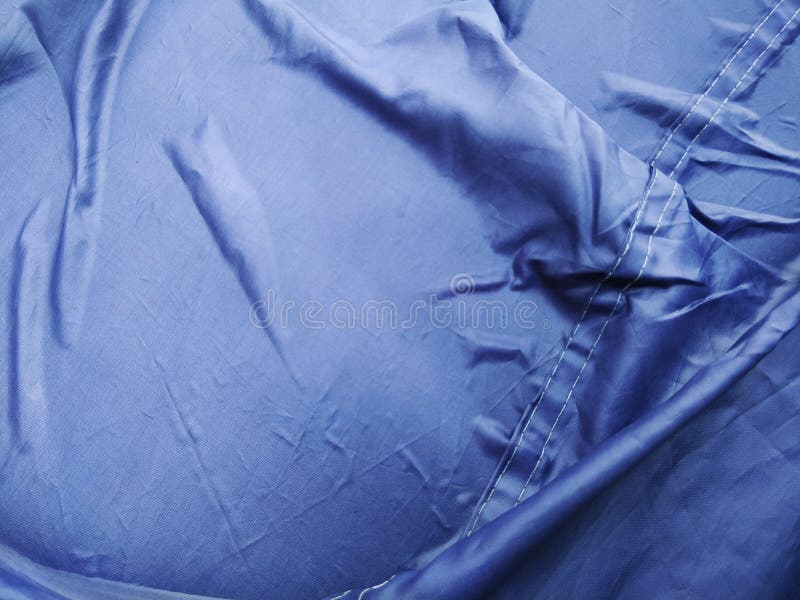 The Blue Plastic Sheet on the Car for Dust and Rain Protection. Stock