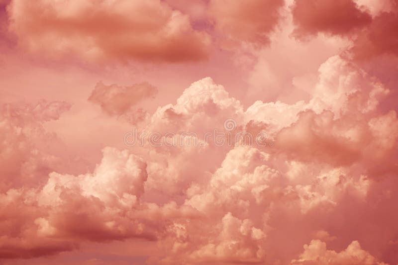 Blue purple red pink orange gold white sky with clouds. Sunset evening sun. Cloudy dramatic background. Peach fuzz color 2024.