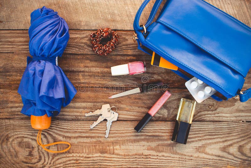 Blue purse, umbrella and womens accessories.