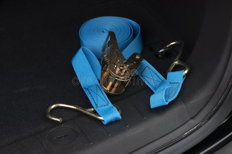 Blue Ratchet Tie in a Car Trunk. Concept Safe Transportation of Goods
