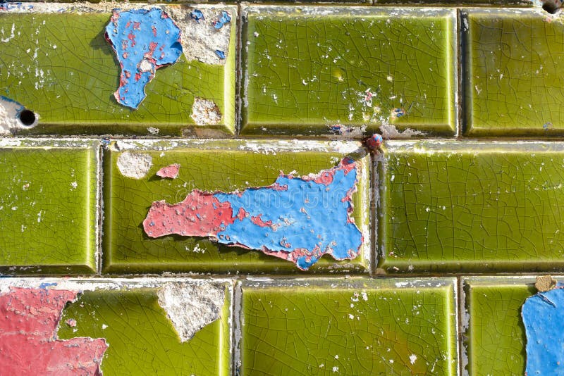 Blue and Red Paint Peeling Off Green Ceramic Wall Tiles Stock Image