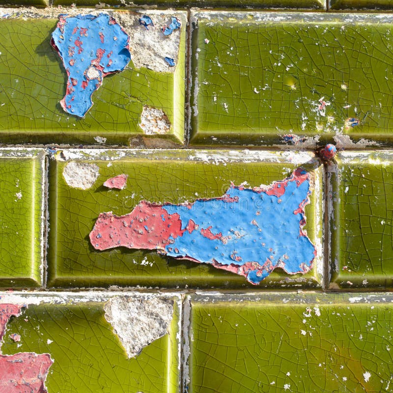 Blue and Red Paint Peeling Off Green Ceramic Wall Tiles Stock Image