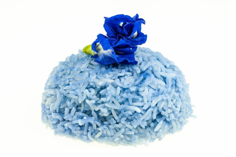 Blue Rice cooked with flowers of Butterfly Pea. Selective focus on white stock image.