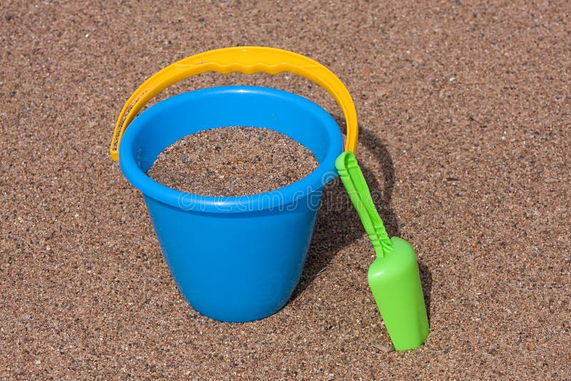 Blue Sand Bucket & Green Shovel on the Beach Stock Image - Image of ...