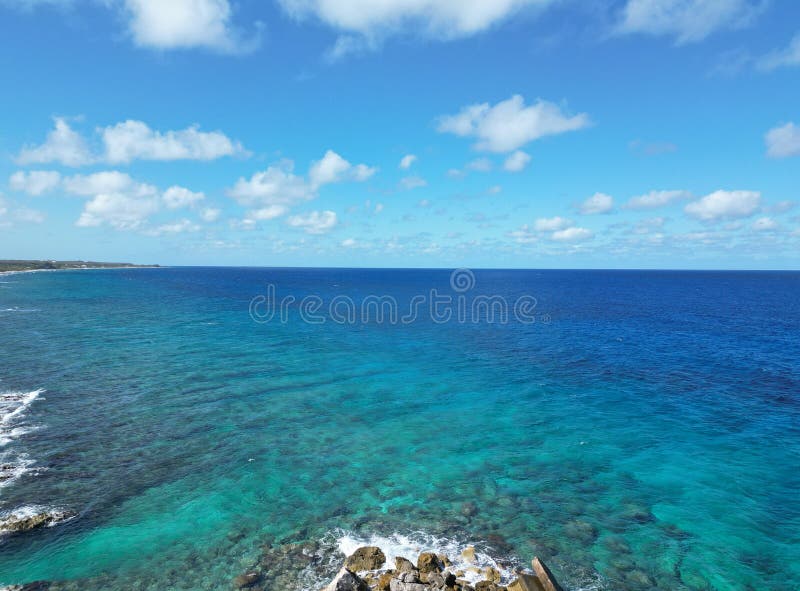 Blue sea ocean sky with white clouds in Grand Cayman sister island Cayman Brac