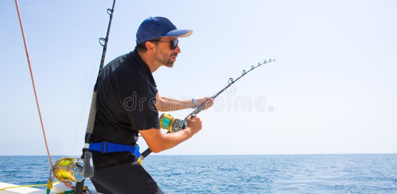 Blue sea offshore fishing boat with fisherman holding rod in action