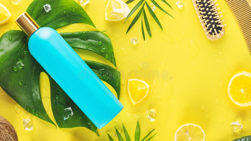 Blue shampoo bottle with combs and slices of citrus fruits