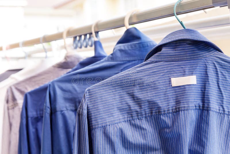 Hangers With Clothes On Garment Conveyor At Dry-cleaner's Stock Photo,  Picture and Royalty Free Image. Image 198000170.