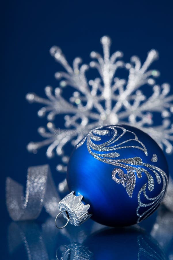 Blue and Silver Christmas Ornaments on Dark Blue Background Stock Photo