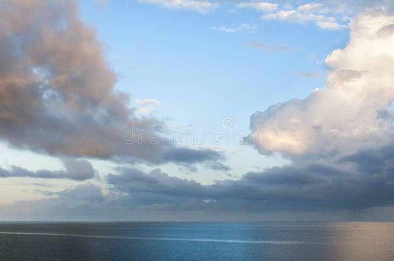 Blue skies, clouds and sea.