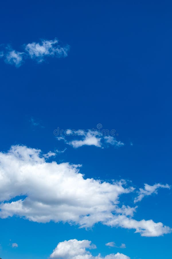 Blue sky background with white clouds vertical image