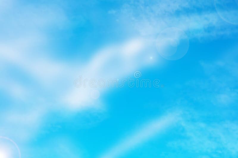 Blue sky with cloud background. Abstract realistic blue sky with delicate fluffy clouds, stars and romantic glamourous sun flair