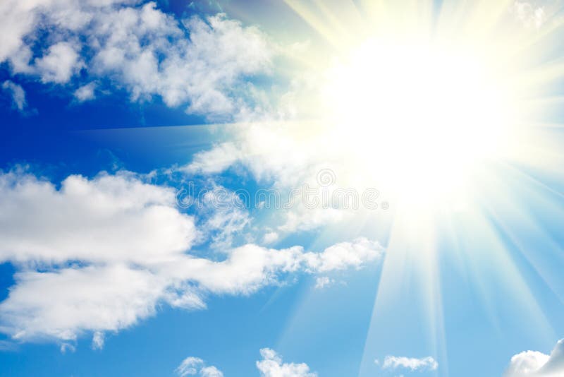 Blue sky with clouds and sun with rays of light