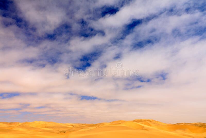 Blue sky with sand dune. Landscape in Namibia, Africa. Travelling in the desert. Yellow sand hills. Namib Desert, sand dune