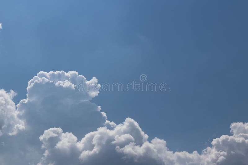 Blue sky with white cumulus clouds on a sunny clear day. Natural background for later design. Prediction of weather on the