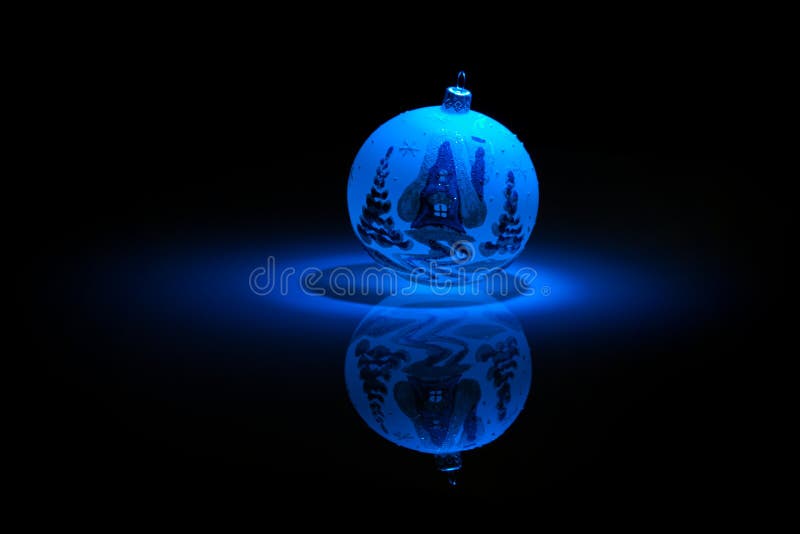 Blue Snowflake bauble on black background.