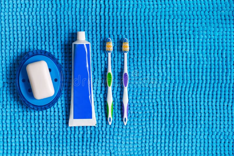 Blue Soap Dish with White Soap, Colored Toothbrushes and Tube of Stock