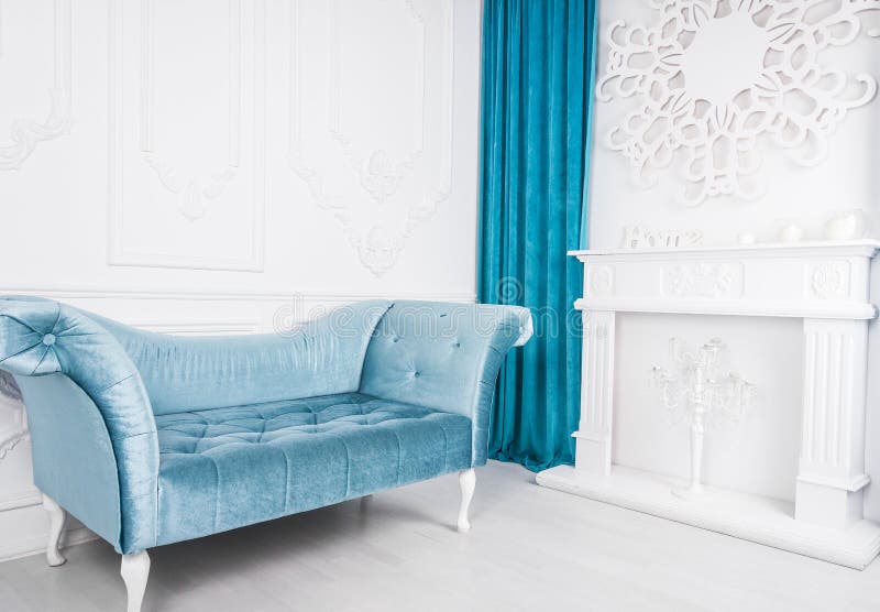 Blue sofa in white interior and gray floor. Venetian style. Decorative fireplace royalty free stock photography Blue sofa in white interior and gray floor. Venetian style. Decorative fireplace royalty free stock photography