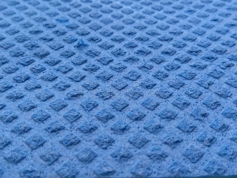Blue Sponge for Washing Dishes, Closeup. Abstract Blue Background