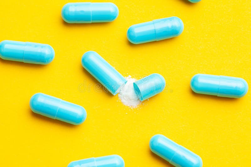 Blue Tablets in Capsules. One Capsule is Open Stock Photo Image of