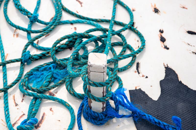 Blue tackle on rustic white boat abstract photo. Rustic blue rope on white wood. White yacht exterior detail