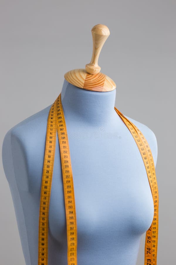 Blue Tailor Dummy with Measuring Tape Alongside the Wall. Stock Image