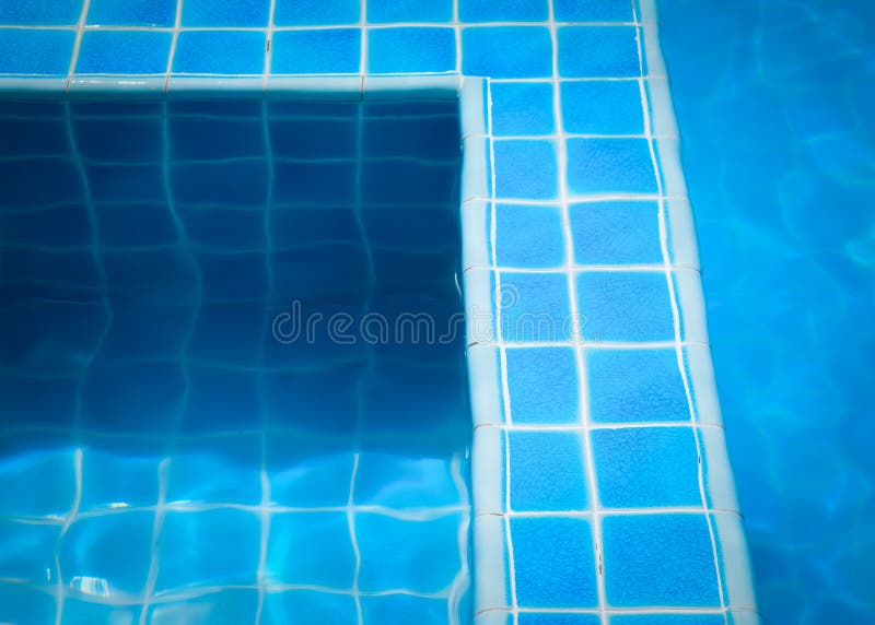 Blue tiles in swimming pool water