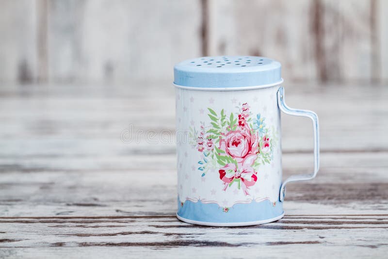 Blue Tin Metal Powdered Sugar Shaker with Floral Pattern Stock Photo