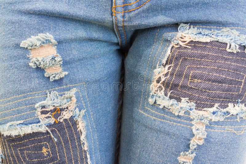 Blue torn denim jeans texture stock photos