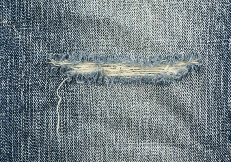 Blue torn denim jeans texture royalty free stock photography