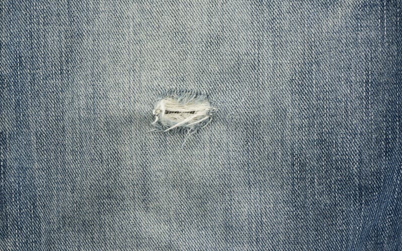 Blue torn denim jeans texture stock photos