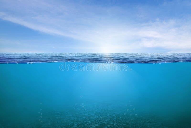 BLUE UNDER WATER waves and bubbles. Beautiful white clouds on blue sky over calm sea with sunlight reflection