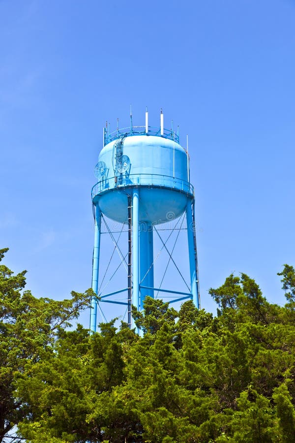 Blue watertower against a blue cloudy sky