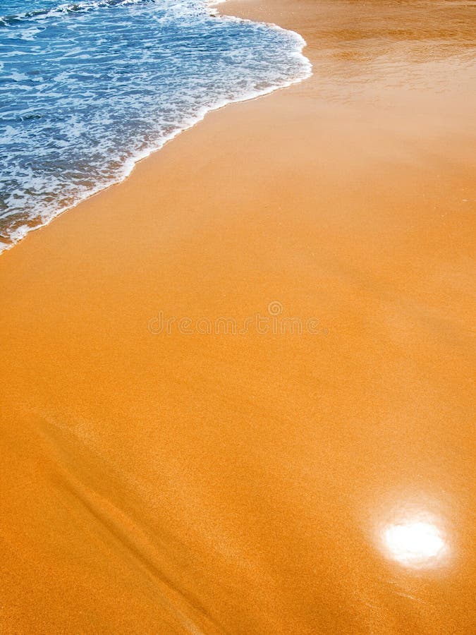 Blue waves on the gilded sand