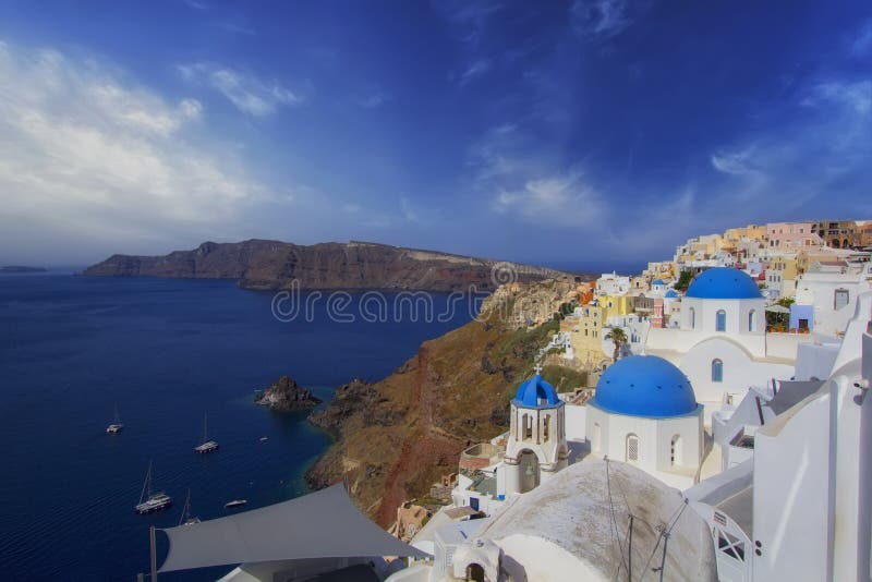 Blue and white colours of Oia City. Magnificent panorama of the island of Santorini Greece during a beautiful sunset in the Medite stock images Blue and white colours of Oia City. Magnificent panorama of the island of Santorini Greece during a beautiful sunset in the Medite stock images