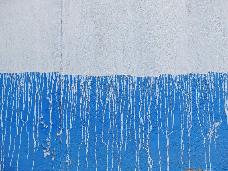 Blue and White Concrete Wall with White Streaks of Paint Stock Image